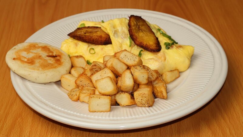 Eggs topped with plantains and potatoes