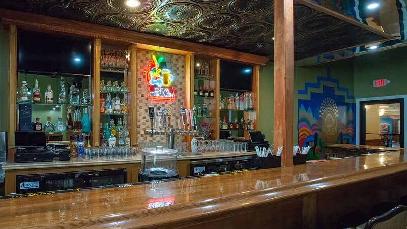 Bar area with neon Inka Chicken sign